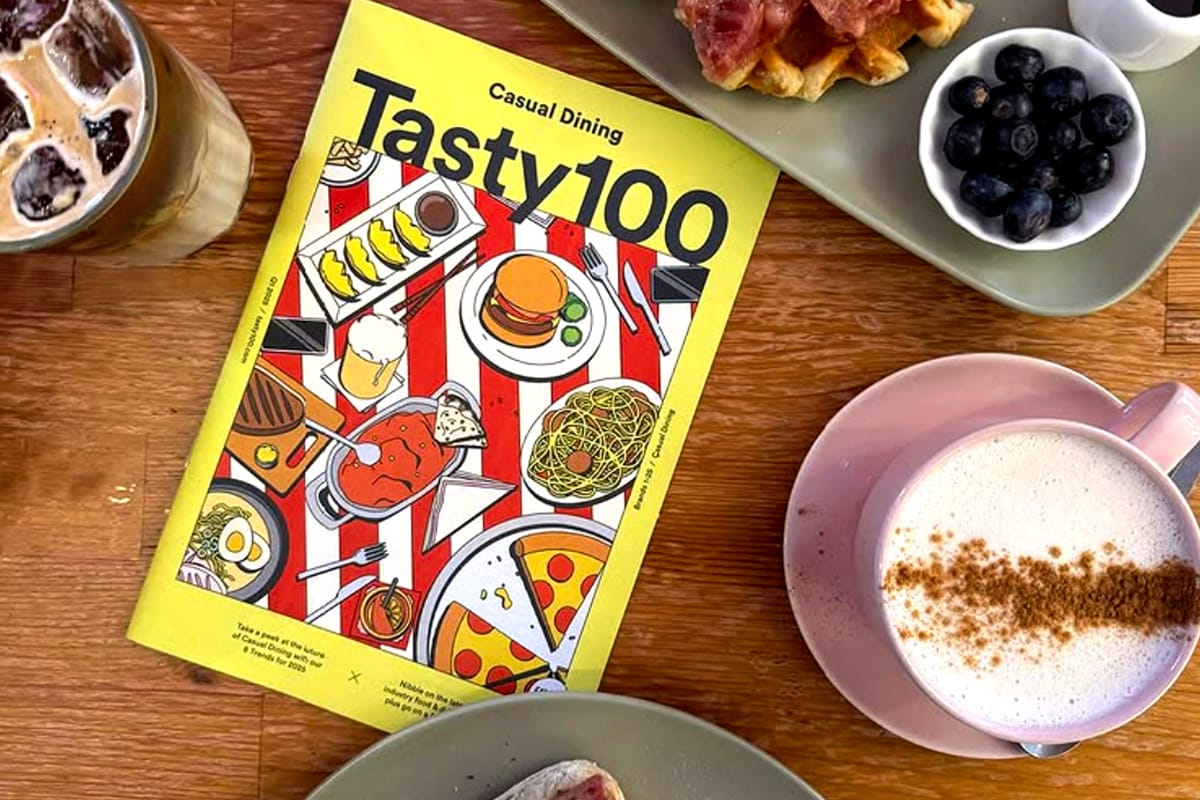 Casual Dining Tasty 100 magazine on wooden table with coffee